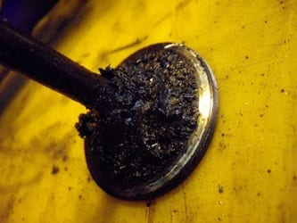 Exhaust valve without treatment — carbon build-up causing pitting