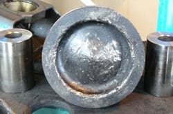 Piston hammered by a dropped valve — severe engine damage