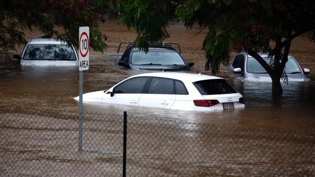 Vehicle caught in rising flood waters
